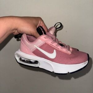Pink and white Nike airmax 11c